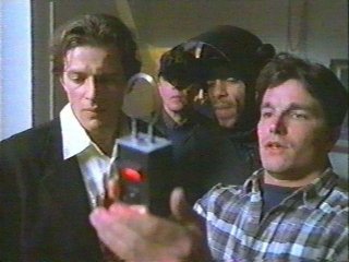 The guys checking out a tracking device in "Contraband"